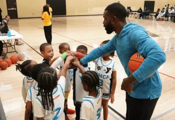 Youth Basketball 2025 - kids huddled in a circle